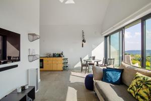 a living room with a couch and a table at villa relax with swimming pool and mountain view in Buków
