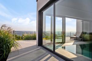 a glass house with a view of the ocean at villa relax with swimming pool and mountain view in Buków