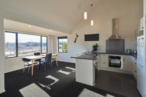 a kitchen and dining room with a table and chairs at Cass Crib - Lake Tekapo in Lake Tekapo