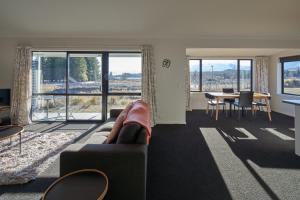 a living room with a couch and a table at Cass Crib - Lake Tekapo in Lake Tekapo