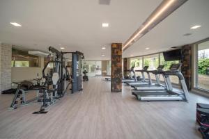 a gym with a row of treadmills and ellipticals at Golden Gramado Resort in Gramado