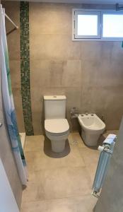 een badkamer met toilet, bad en wastafel bij MH Buona Vista in Monte Hermoso +53 foto's