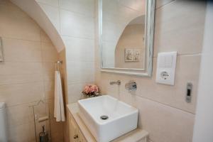 a bathroom with a white sink and a mirror at Casa do Povo in Elvas +73 photos