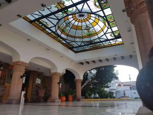 a room with a stained glass ceiling in a building at Best Western Toluca in Toluca