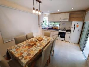 a kitchen with a table with chairs and a dining room at la elegida in Mar Azul +16 photos