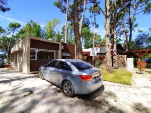 a car parked in front of a house at la elegida in Mar Azul