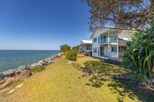 a house on the shore of the ocean at Ocean Pearl - 3 bedroom beachfront property! in Beachmere