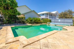 a swimming pool in the backyard of a house at Ocean Pearl - 3 bedroom beachfront property! in Beachmere