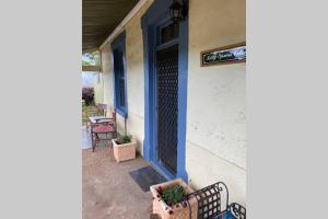 a porch with a bench in front of a building at Kitty Spain's Cottage in Mannum