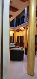 a room with two beds in a building with columns at Hotel Mina Vetagrande in Zacatecas