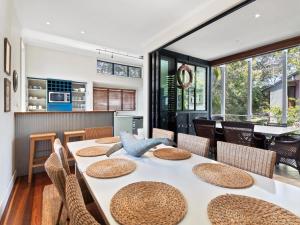 a dining room with a table and chairs at Baleen Beach House by Discover Stradbroke in Point Lookout