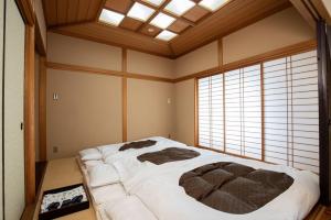 a large bed in a room with a large window at Hotel Cadenza Tokyo in Tokyo +27 photos
