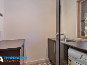 a kitchen with a sink and a counter top at Ice Chalet 2 in Thredbo +9 photos
