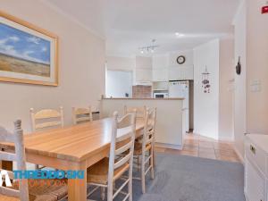 a kitchen and dining room with a wooden table and chairs at Kaella in Thredbo