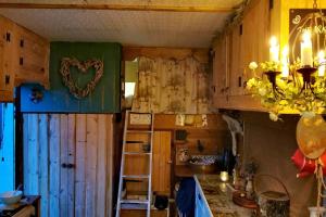 a kitchen with wooden cabinets and a heart on the wall at Glamp in Style in an Unique Horsebox Home in Battle