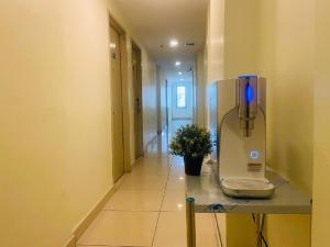 an empty hallway with a appliance on a table at Asia Like Boutique Hotel in Kuala Lumpur