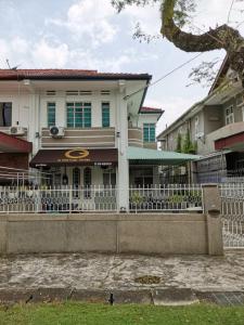 a white fence in front of a house at G Fortune Guest House Victoria Green in George Town