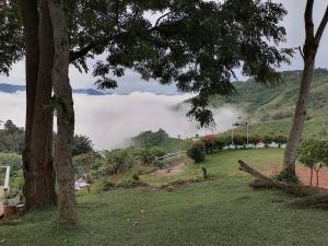 a view of a hill with clouds in the distance at Ban Chomdoi Resort PhaTang in Ban Pha Tang