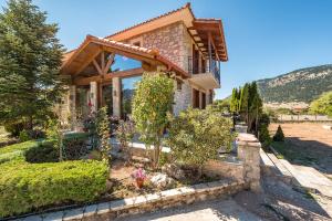 a house with a garden in front of it at Arachova Mountain Villa in Arachova