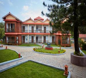a large building with trees and a courtyard at Sea Queen Beach Resort & Spa in Colva