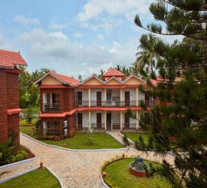 an image of a house with a yard at Sea Queen Beach Resort & Spa in Colva