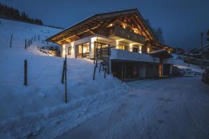un rifugio da sci nella neve di notte di Elegantes Chalet Steinbock für die Zeit zu Zweit a Jungholz