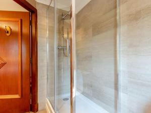 a shower with a glass door in a bathroom at Dalgarven spa venue in Kilwinning