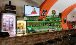 a bar with a television on top of it at Penzion Willa in Jihlava