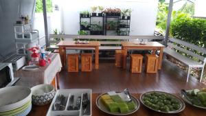 a balcony with a table and plates of food at Bannsukta in Na Jomtien