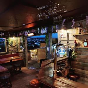 a bar with a view of a city at night at Serendipity House in Derry Londonderry