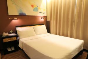 En eller flere senger på et rom på Best Western Plus Tsim Sha Tsui
