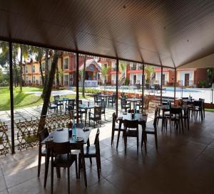 a group of tables and chairs in a patio at Sea Queen Beach Resort & Spa in Colva