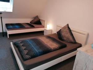 a room with two beds and a table with a lamp at Ferienwohnung,Haus Elisa 2 in Stendal