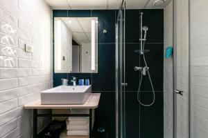a bathroom with a shower, sink, and toilet at Appart'City Confort Montpellier Saint Roch in Montpellier