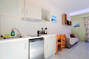 a kitchen with a sink and a dishwasher at Stalaktites Studios in Sami