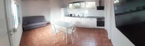 a small kitchen with a table and a chair in it at Puestita de Sol in Frontera