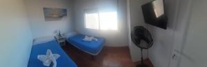 a room with a blue ottoman and a window at Puestita de Sol in Frontera