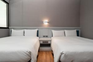 Postel nebo postele na pokoji v ubytování Fu Hsiang Hotel