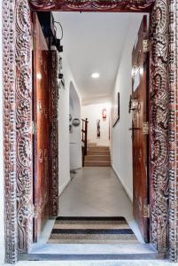 une porte ouverte menant à un couloir avec des escaliers dans l'établissement Kelele Square, à Zanzibar City