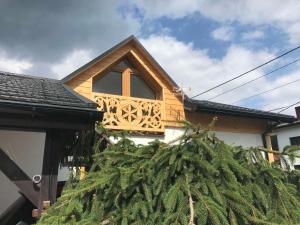 a christmas tree on the side of a house at Świstakówka in Szczyrk