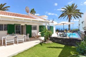 a villa with a patio and a swimming pool at Chalet Golden Sahara by VillaGranCanaria in Playa del Ingles