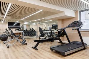 a gym with several treadmills and exercise bikes at Garden Street Hotel in Saint Petersburg