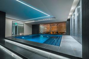 a large swimming pool in a building at Messier 53 Hotel Yerevan in Yerevan