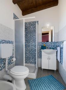 a blue and white bathroom with a toilet and a sink at Arricàmpati Airport Home & Bringo Car Rental in Carini