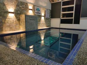 a swimming pool in a house with a tile wall at D'Q Putra Homestay Melaka Unit MIQA in Melaka