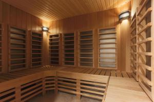 a sauna with wooden racks and lights in it at Garden Street Hotel in Saint Petersburg