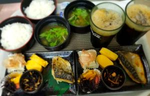 a tray of sushi and other foods and drinks at TsukinoAkari月燈 姫路城隣 in Himeji