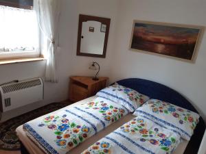 a bedroom with a bed with two pillows on it at Chata Ľubka in Vyšné Ružbachy