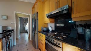 a kitchen with wooden cabinets and a stove top oven at San Lameer Villa 2910 by Top Destinations Rentals in Southbroom +22 photos