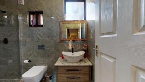 a bathroom with a sink and a toilet and a mirror at San Lameer Villa 2910 by Top Destinations Rentals in Southbroom